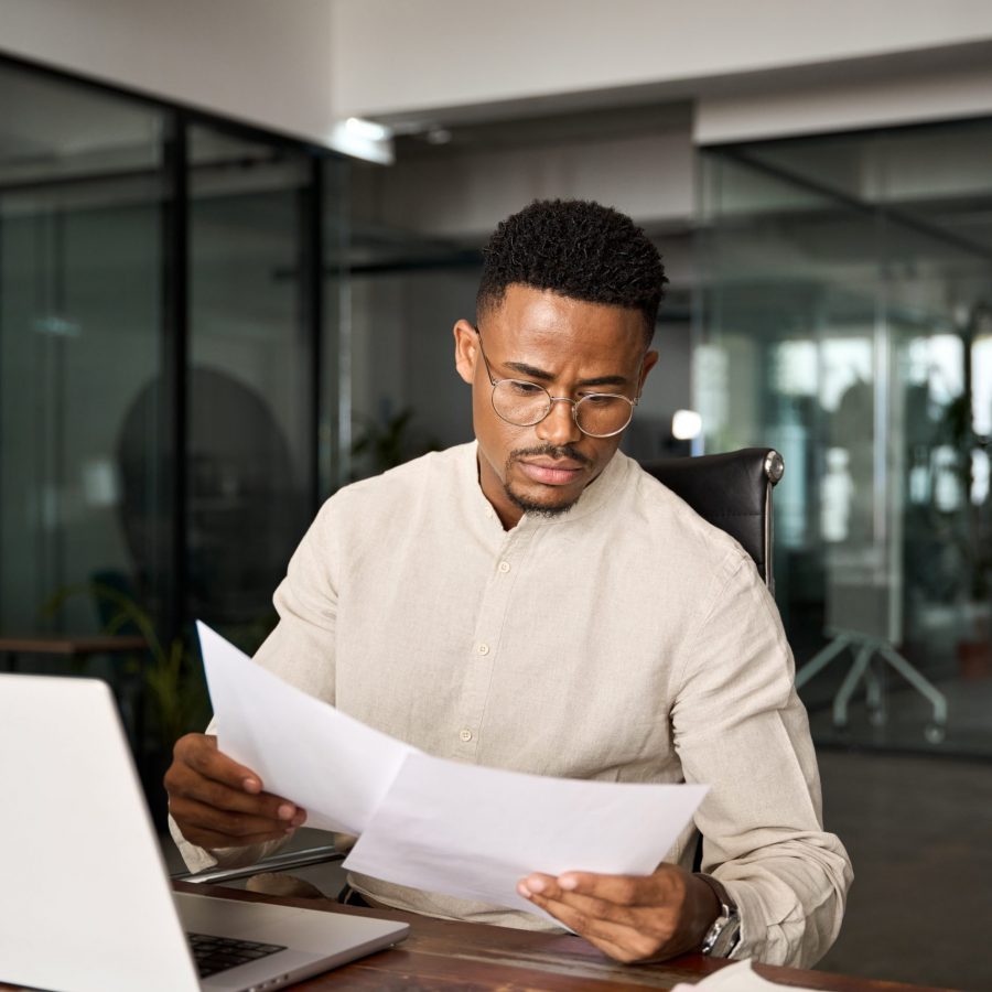 Busy,African,American,Lawyer,Checking,Documents,Working,At,Laptop,In